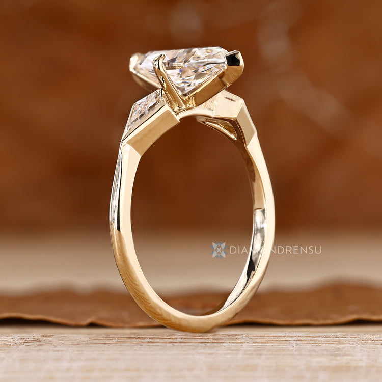 Three stone diamond ring with two V prongs.