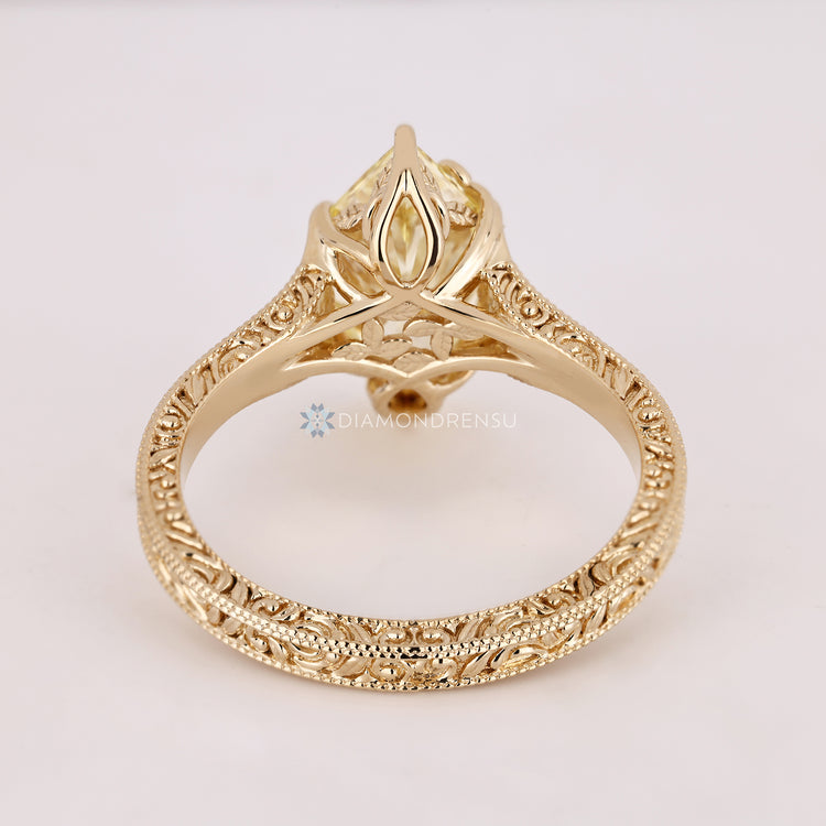Blooming Flower Bud Setting surrounds the center diamond.