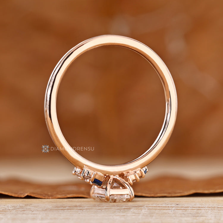 Asymmetrical cluster ring with a four claw prong setting.