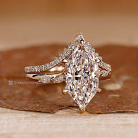 Six claw prong setting secures the center diamond.