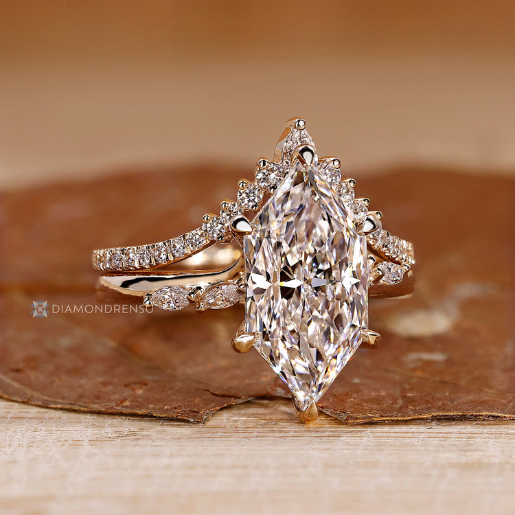 Six claw prong setting secures the center diamond.