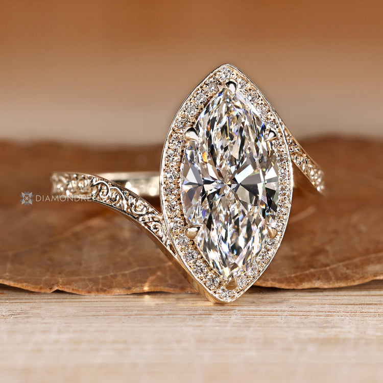 Marquise diamond ring with round diamond halo setting.
