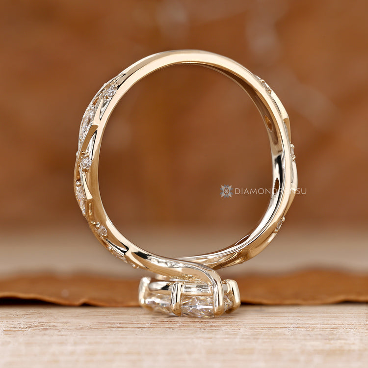 Vintage style marquise engagement ring with round and marquise side stones.