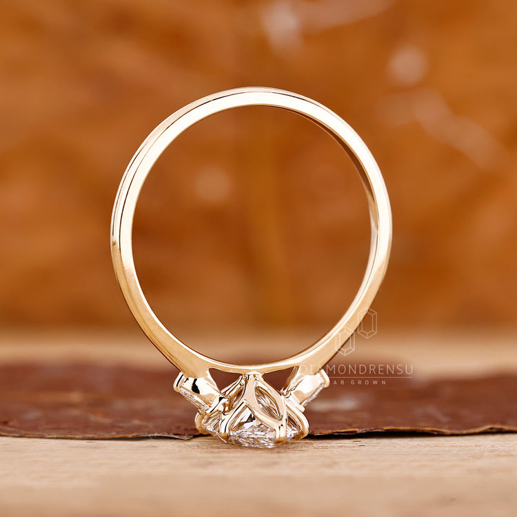 Handmade marquise engagement ring with pear side diamonds.
