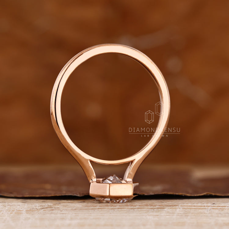 Solitaire coffin diamond ring with cathedral setting details.