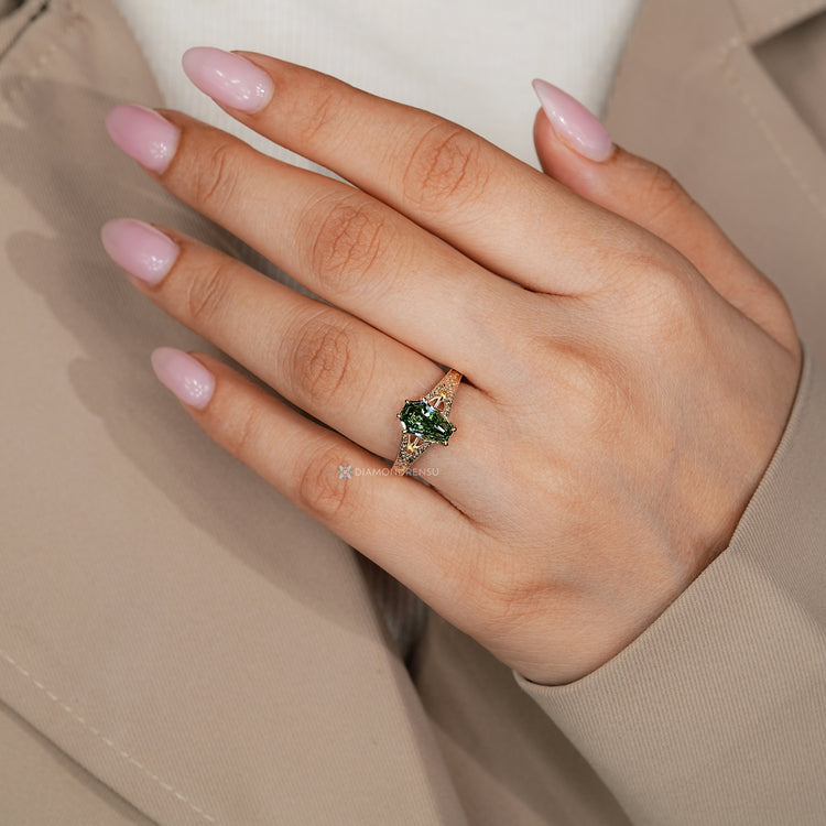 Green coffin cut diamond ring with a six claw prong setting.