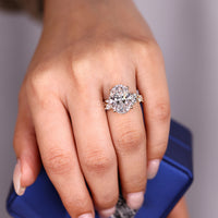 Cluster setting oval diamond ring with four claw prong setting.

