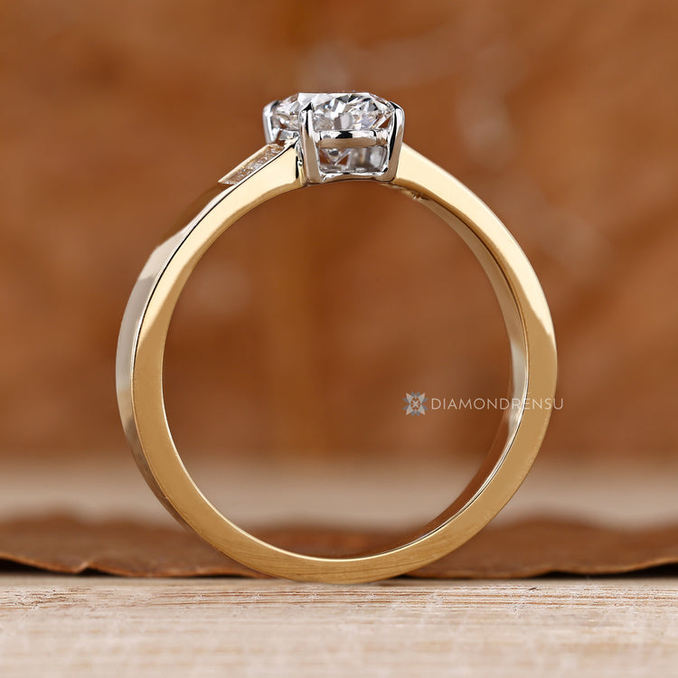 Oval diamond ring with two tone gold setting.