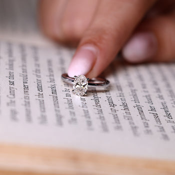 IGI certified oval diamond engagement ring with lab grown diamond.