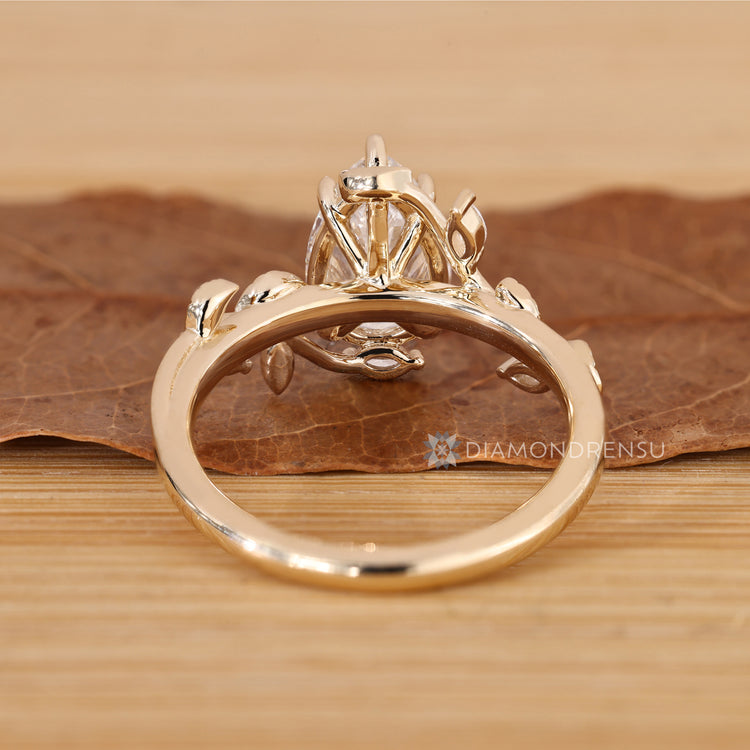 Pear cut engagement ring with marquise side stones.