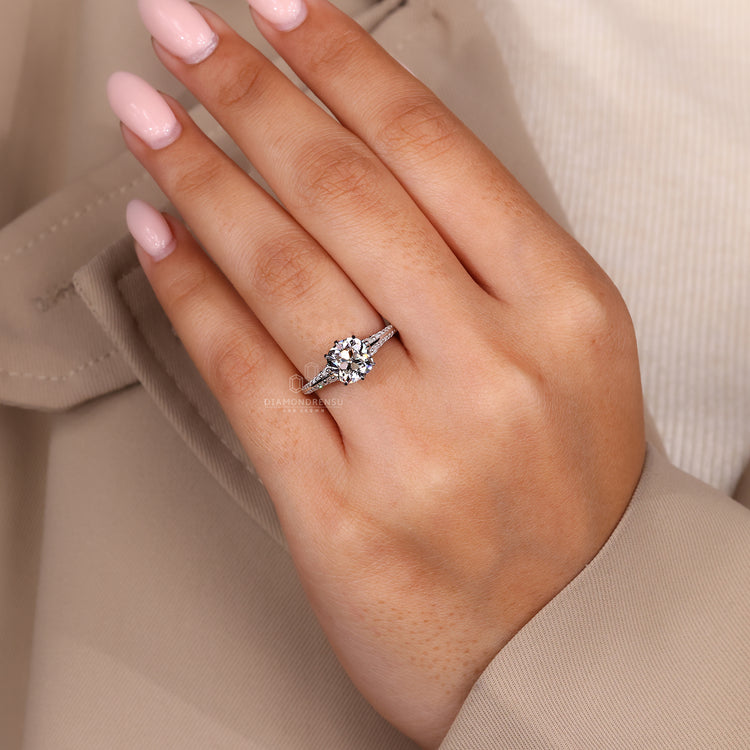 Cushion old european diamond ring with double side pave and prong setting.
