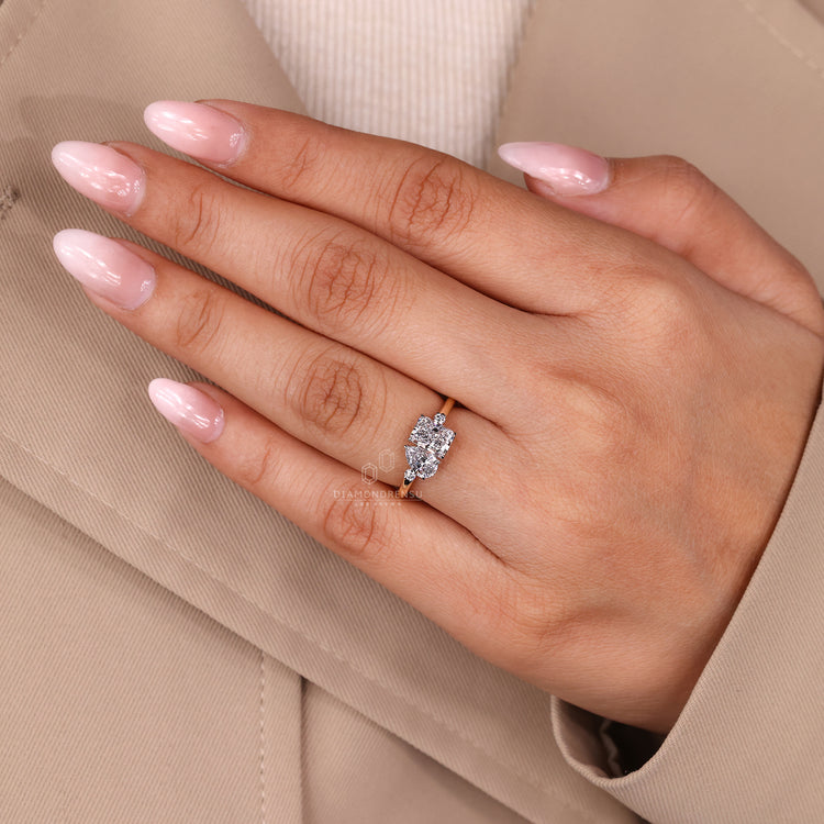 Claw prong two stone ring with pear and radiant diamonds and round cut sides.