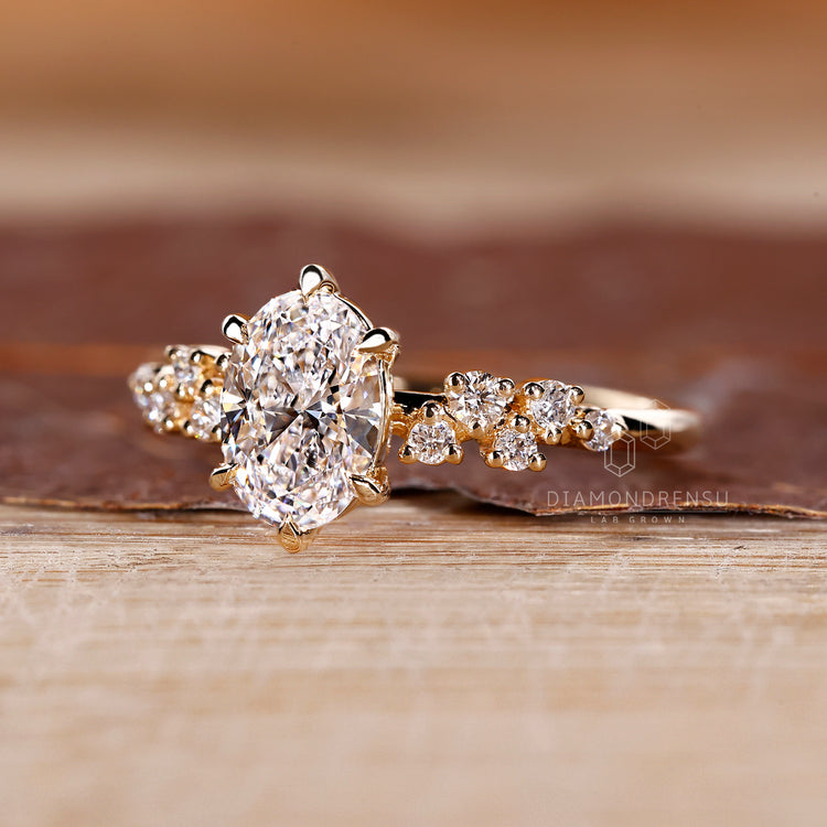 Handmade oval diamond ring with detailed cluster design.