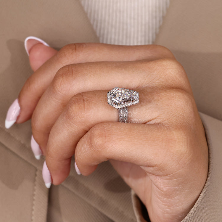 Double band coffin cut ring with round cut halo and engraved filigree.