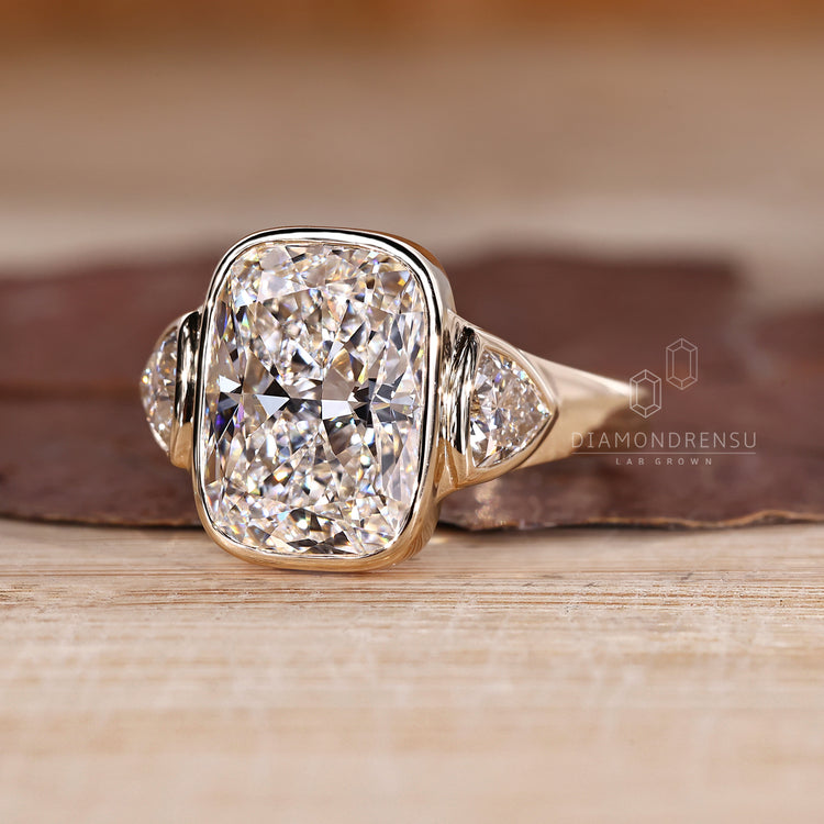 Cathedral setting three diamond ring with tapered shank.

