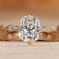 Cushion cut diamond ring with a twisted shank.
