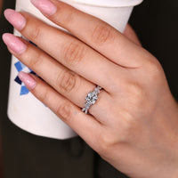 Cushion center stone defines this trellis engagement ring with a twisted pave.