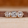 Three stone ring with cushion old european cut diamond center.
