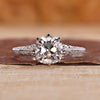 Old european cushion cut diamond with round double side pave band.

