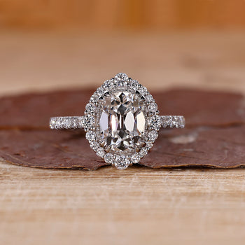 Cushion old mine cut diamond with round cut halo and pave band by Diamondrensu.

