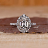 Cushion old mine cut diamond with round cut halo and pave band by Diamondrensu.
