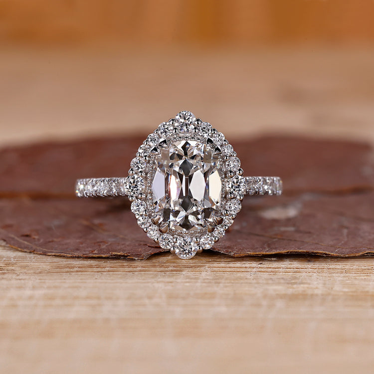Cushion old mine cut diamond with round cut halo and pave band by Diamondrensu.

