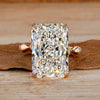 Radiant cut diamond ring with round diamond distance pave band.
