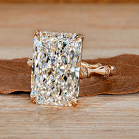 Radiant cut diamond ring with trellis setting and pave band.
