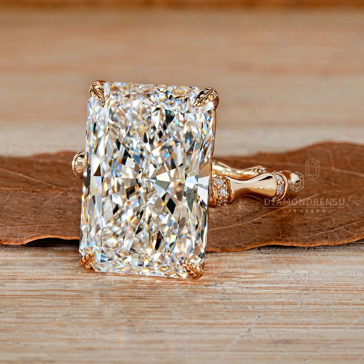 Radiant cut diamond ring with trellis setting and pave band.
