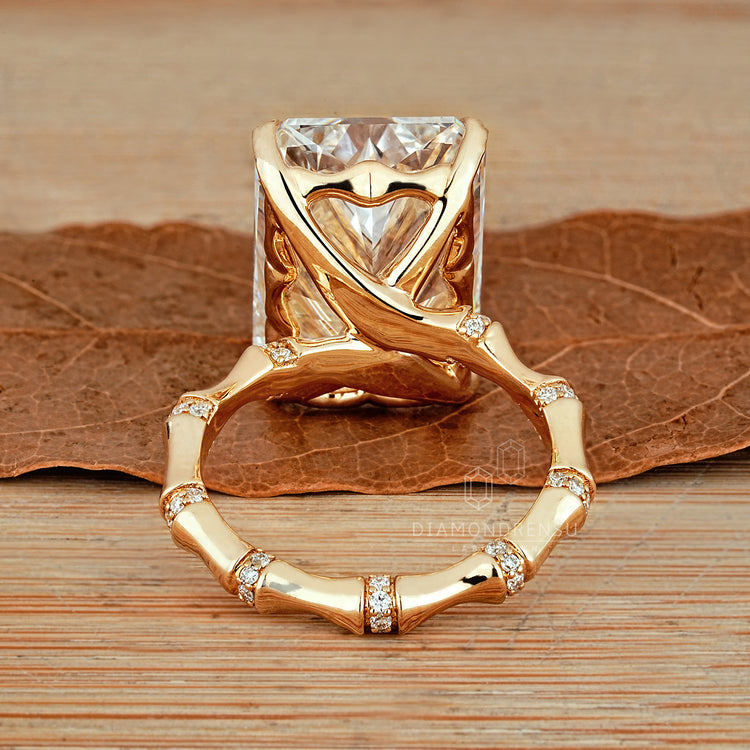 Radiant cut diamond ring with round diamond distance pave detail.
