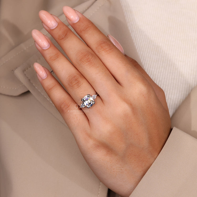 Cushion old mine center stone with pear cut side diamonds setting.