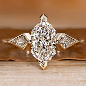 Three stone diamond ring with a Dutch marquise center.