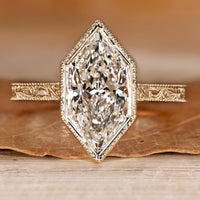 Art Deco engagement ring with Dutch marquise center stone and milgrain details.
