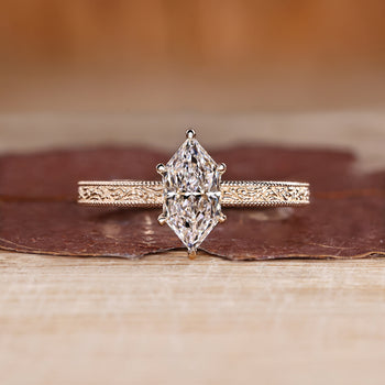 Dutch marquise ring in solitaire style with ocean waves design band.