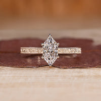 Dutch marquise ring in solitaire style with ocean waves design band.
