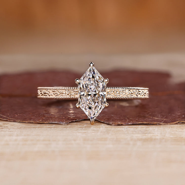 Dutch marquise ring in solitaire style with ocean waves design band.