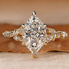 Dutch marquise ring with round side stones and six claw prongs.