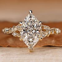 Dutch marquise ring with round side stones and six claw prongs.