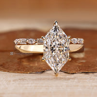Six claw prong setting secures the center stone.