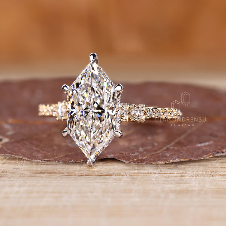 Two tone metal Dutch marquise ring with hidden halo and pave accents.