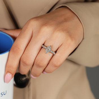 Dutch marquise ring with round and marquise accents on a criss-cross shank.