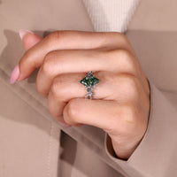 Green diamond ring with moss agate side stones.