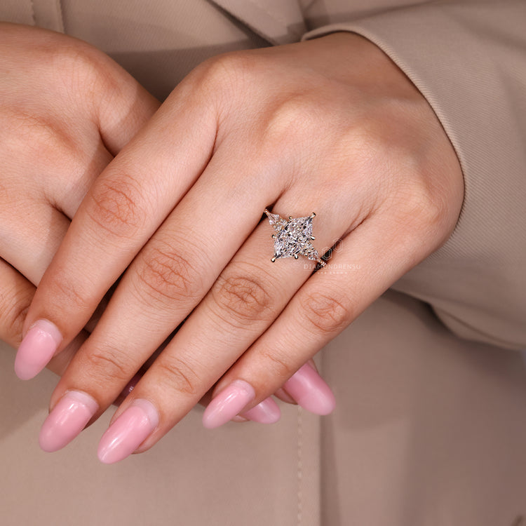 Handmade Marquise Diamond Ring with round and kite side stones.
