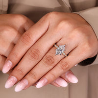 Dutch marquise engagement ring with round cut pave band and claw prong setting.