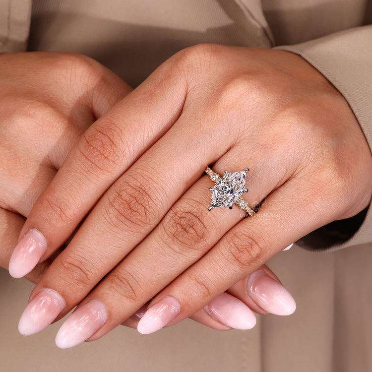 Dutch marquise engagement ring with round cut pave band and claw prong setting.