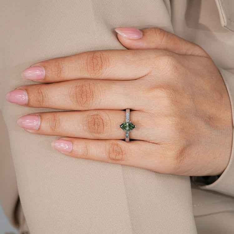 Green Dutch marquise diamond ring with a round stone bridge accent.