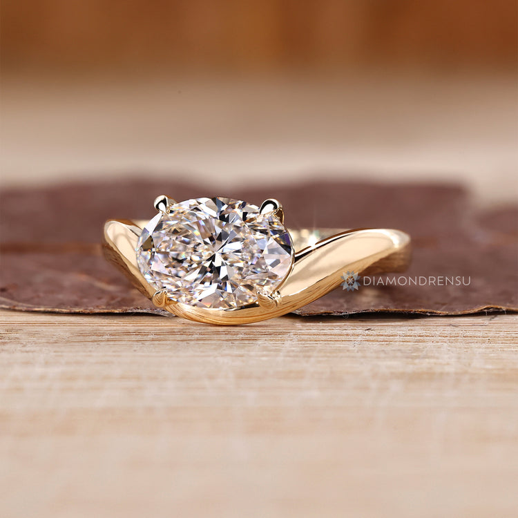 Diamondrensu oval ring with lab grown diamond center stone.