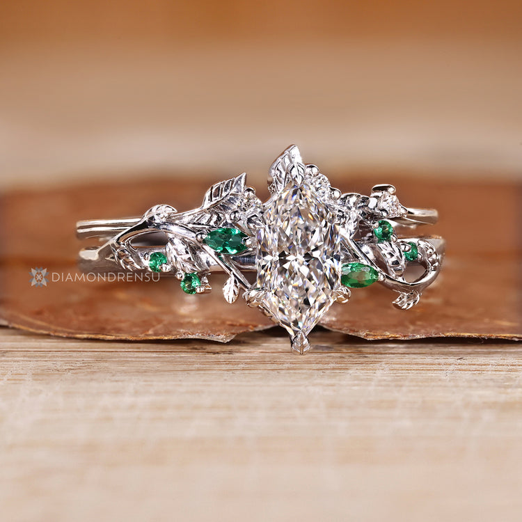Six leaf style prong setting secures the Dutch marquise center stone.