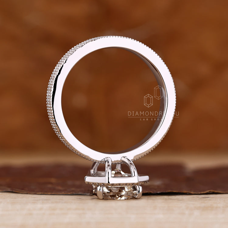 Handmade coffin cut engagement ring with round cut halo and filigree design.