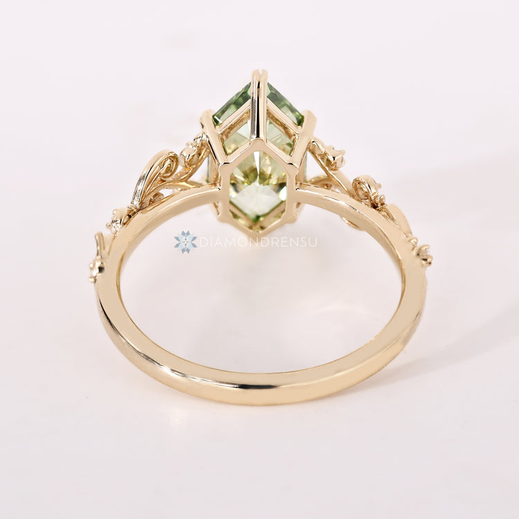 Green Dutch marquise engagement ring with filigree details.